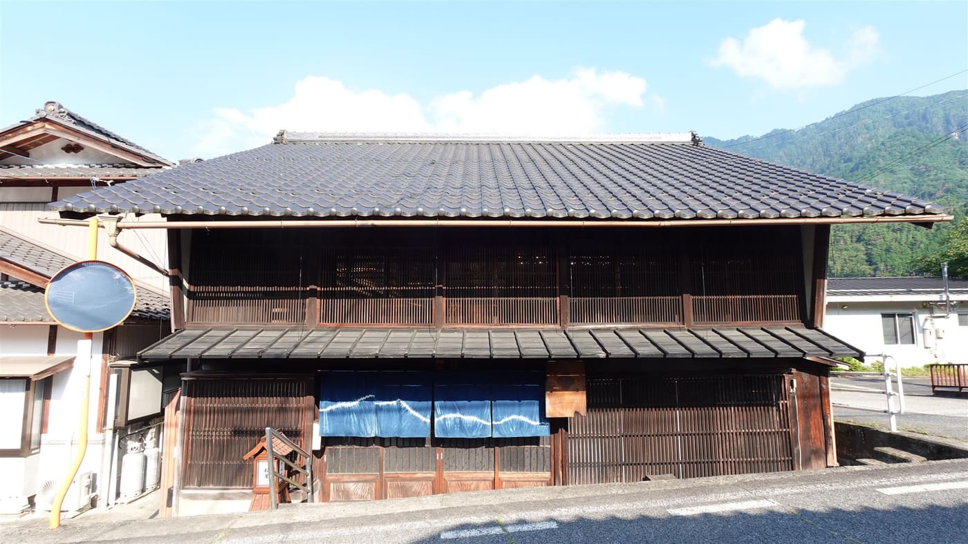 Kashiwaya Guesthouse — an old two-storey wooden inn with indigo noren curtains, Nagiso
