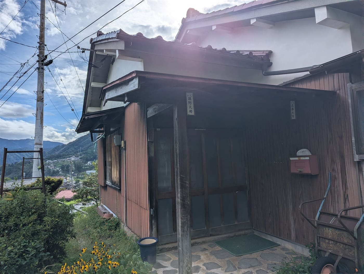 The entrance of the Kitahara house, looking out over the valley and the village below